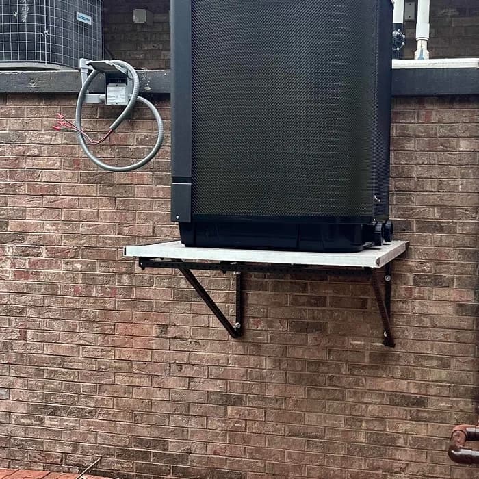Pool heat pump raised on a wall-mounted platform at a home on Siesta Key, Sarasota
