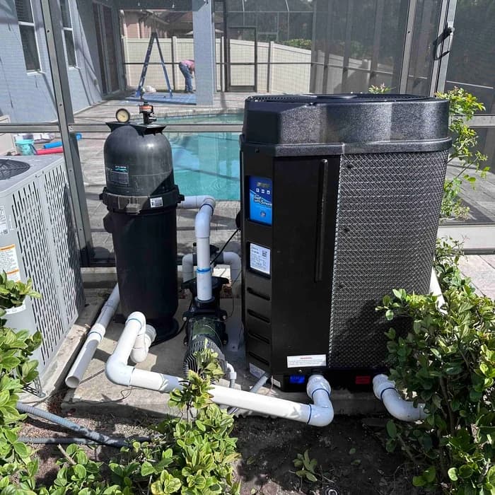 GulfStream pool heat pump installed alongside an existing pool filter and pump in Florida