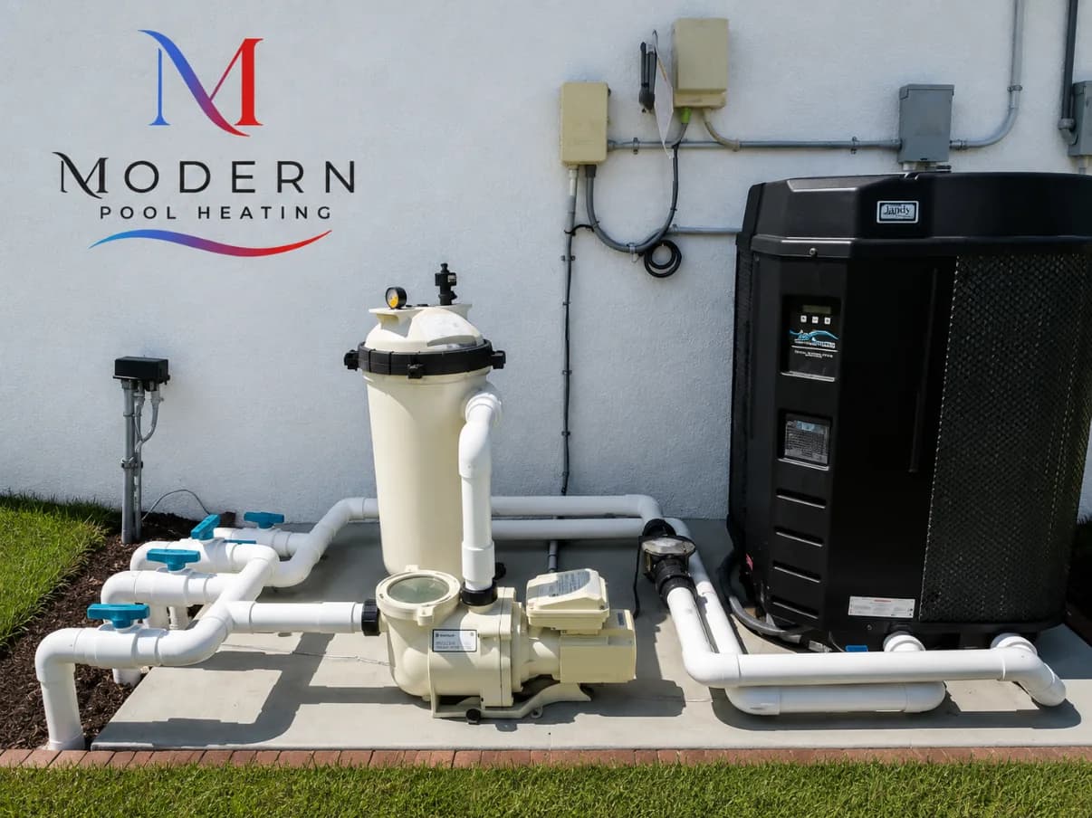 Jandy pool heat pump beside a new Pentair filter and pump on a fresh equipment pad