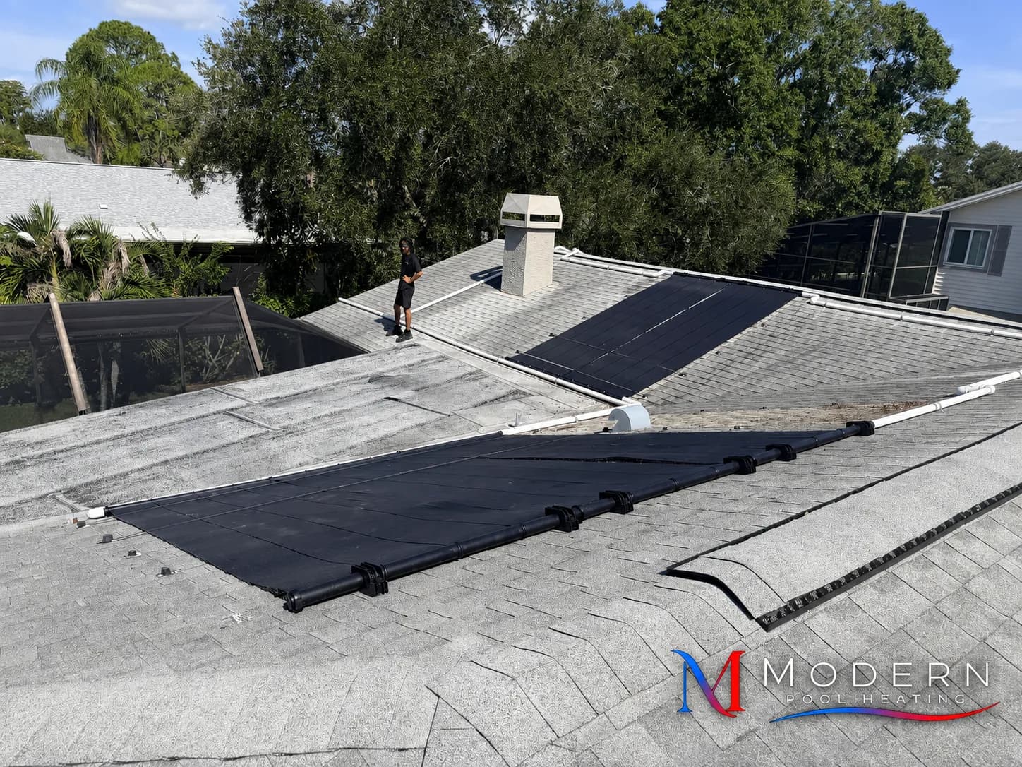 Pool solar collectors installed across a shingle roof in Southwest Florida
