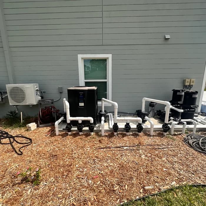 Hayward pool heat pump plumbed into a new PVC valve manifold alongside pool filters